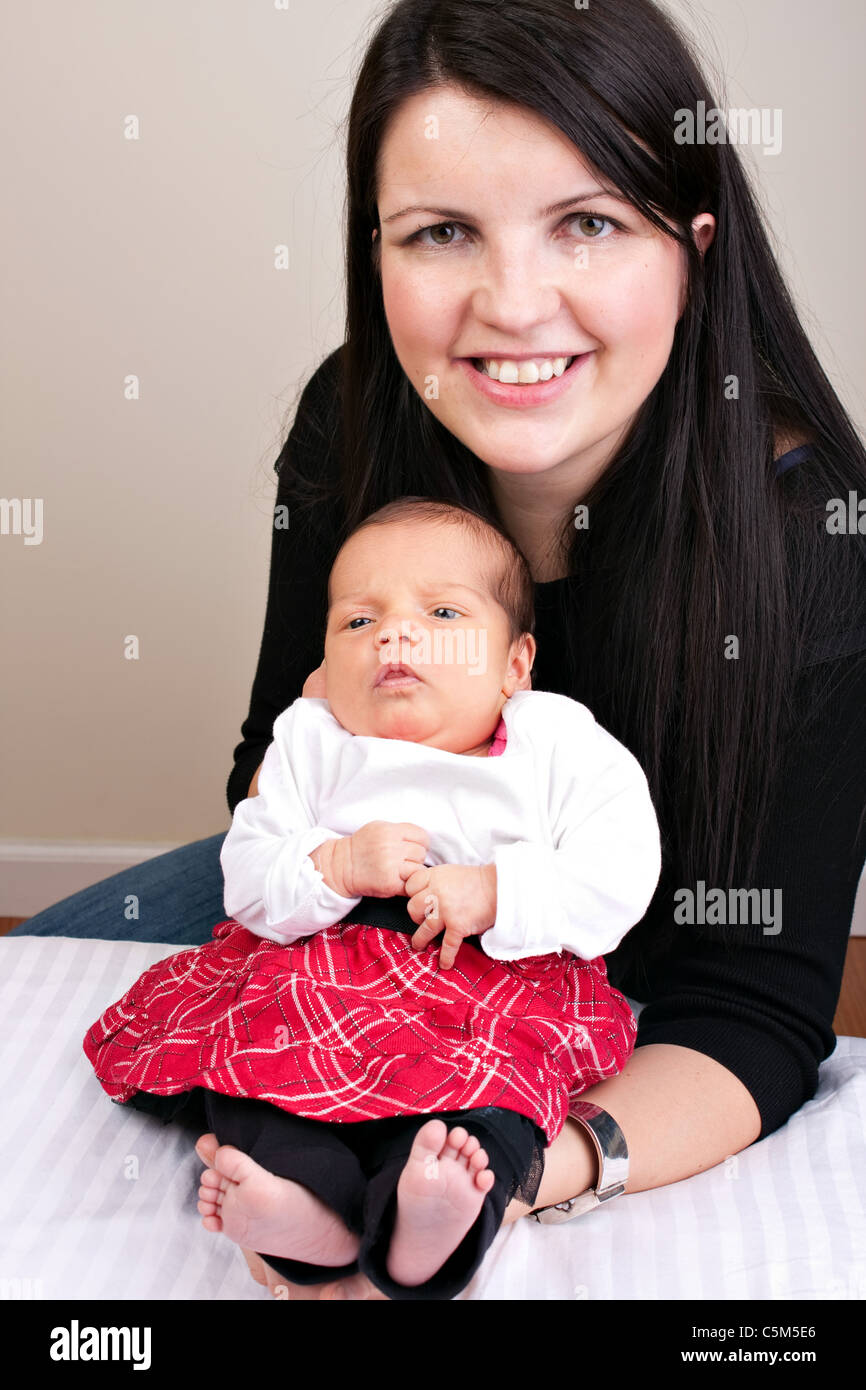 A newborn baby being held in the arms of her mother Stock Photo - Alamy