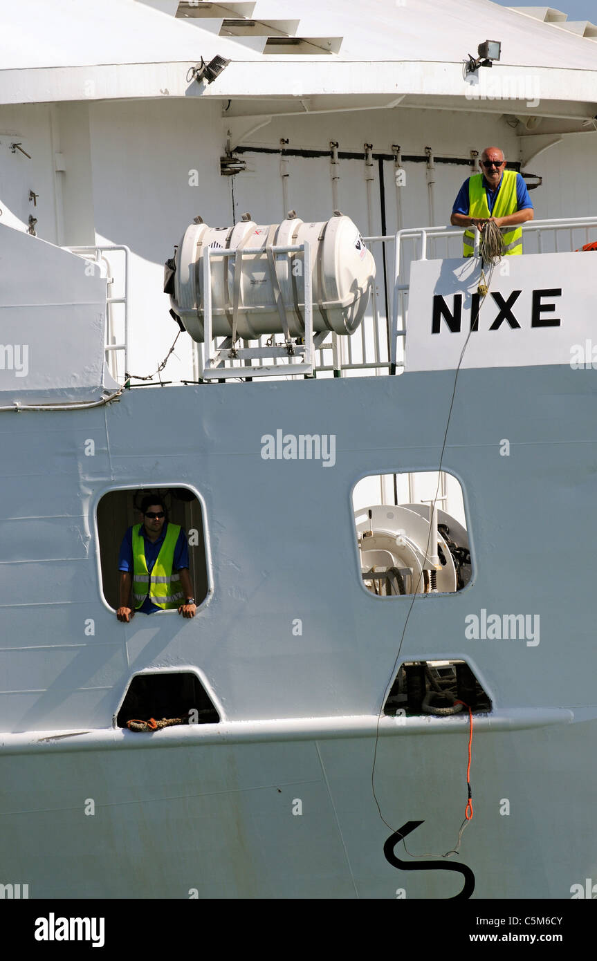 Fast Ferry the Nixe arriving Eivissa Port on the Spanish Island of Ibiza Crew members ready to throw a line Stock Photo