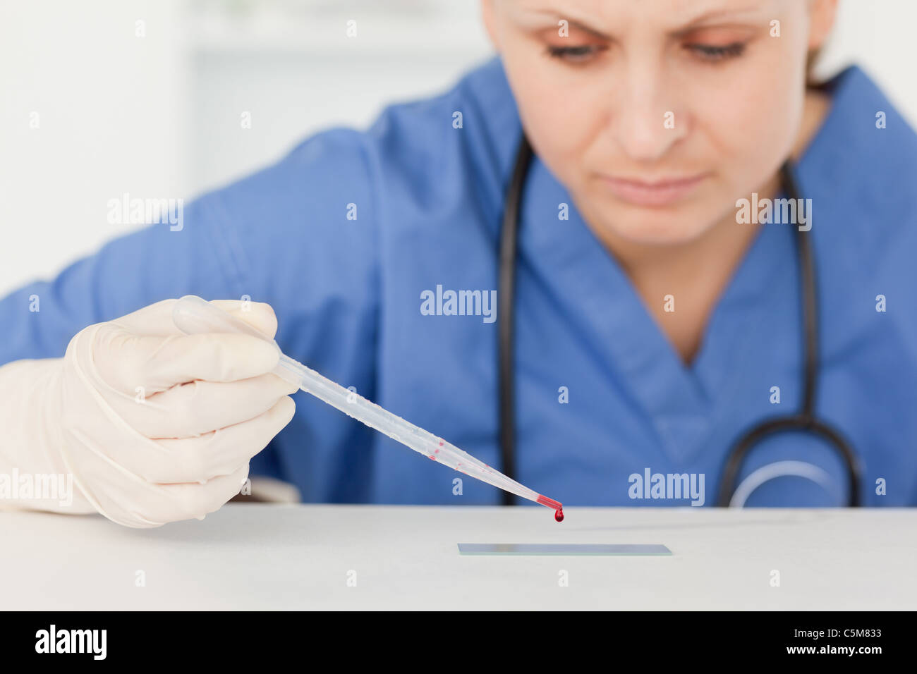 Cute female scientist preparing a microscope slide Stock Photo