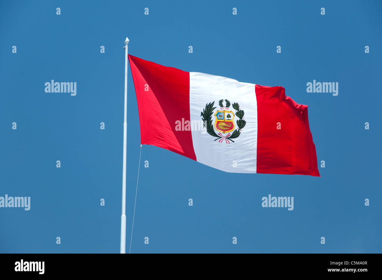 The Peruvian flag against a blue sky. Stock Photo