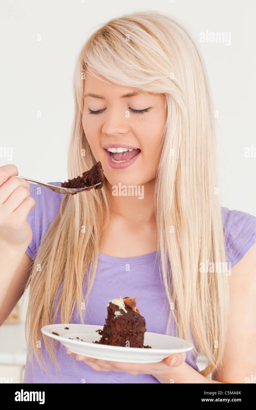 Attractive caucasian female eating cake Stock Photo Alamy
