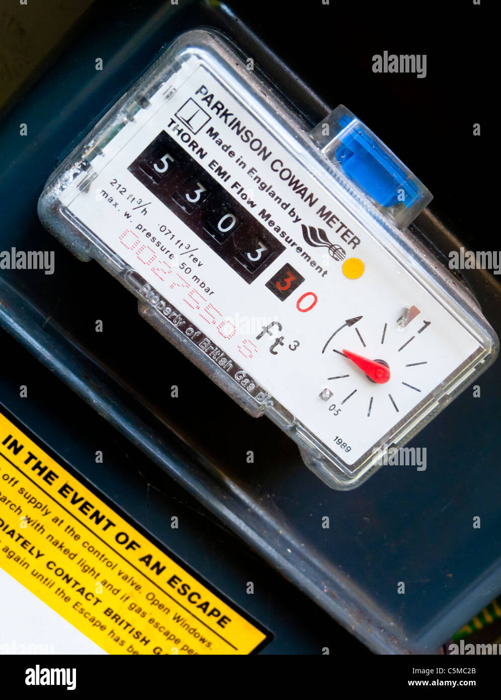 Close up view of domestic gas meter in a UK house showing dials and