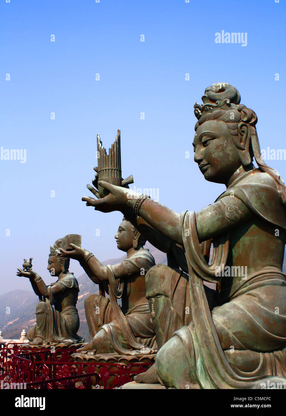 Goddess statues making gift offerings to Buddha Stock Photo Alamy
