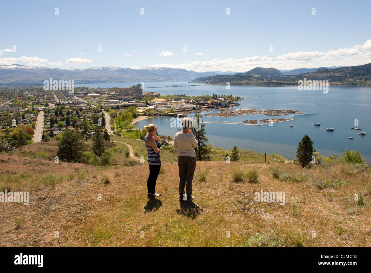 Tourists admiring a view over Okanagan Lake in Kelowna, Canada Stock Photo