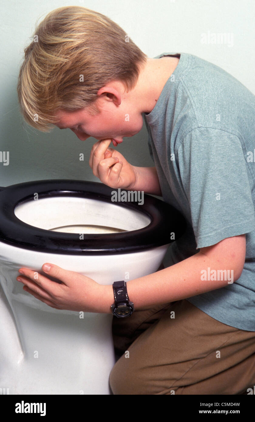bulemic boy forcing himself to vomit into toilet bowl Stock Photo Alamy