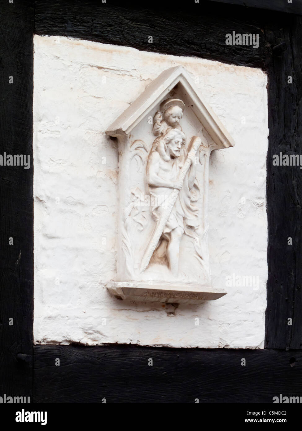 Detail of decorative religious sculpture outside a Tudor house in Lichfield Staffordshire England UK Stock Photo