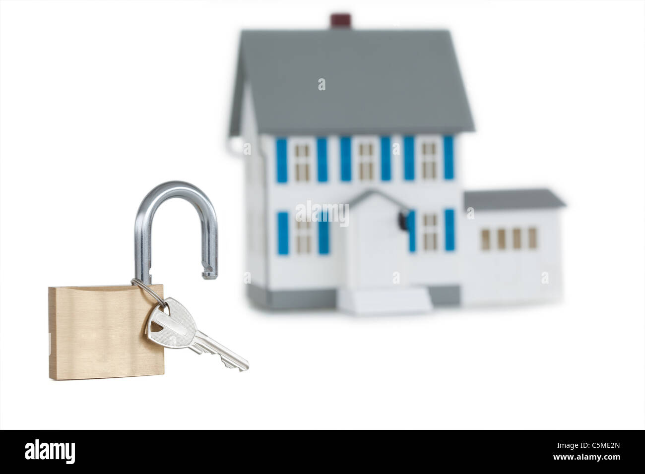 Miniature house and opened padlock Stock Photo