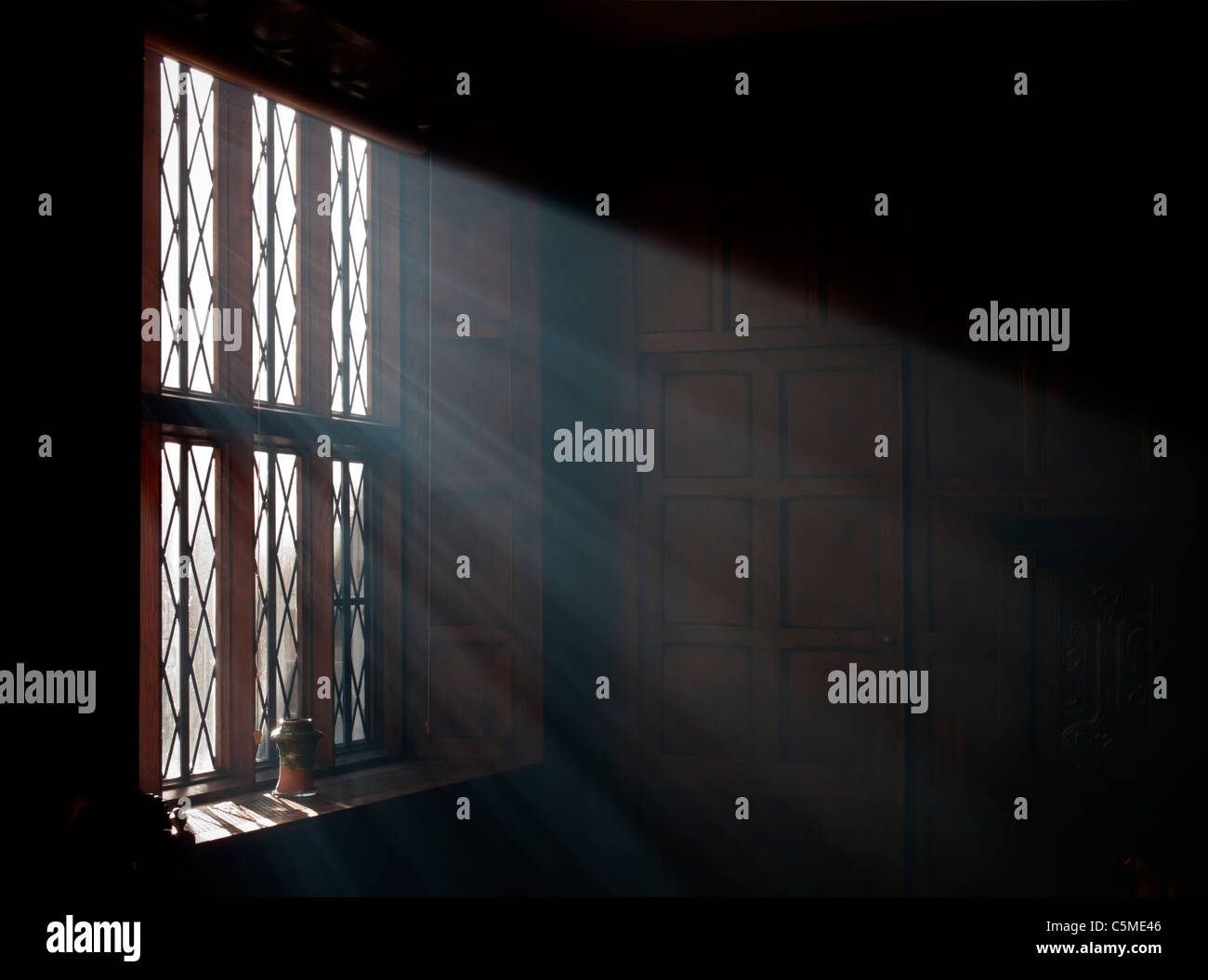 Bright sunlight streaming through a window with shafts of light visible Stock Photo