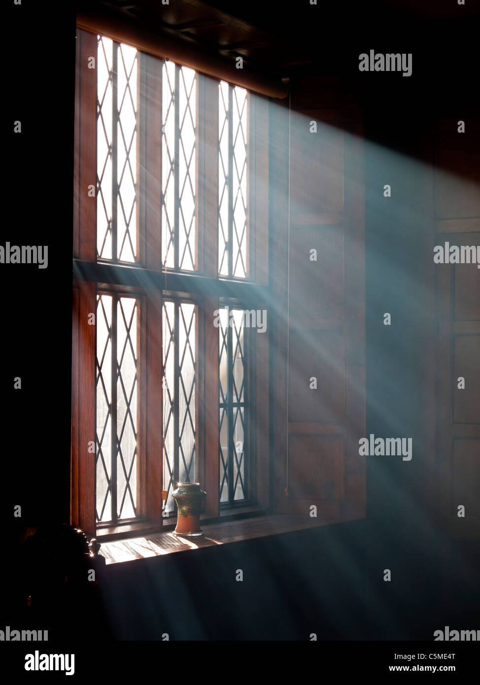 Bright sunlight streaming through a window with shafts of light visible Stock Photo