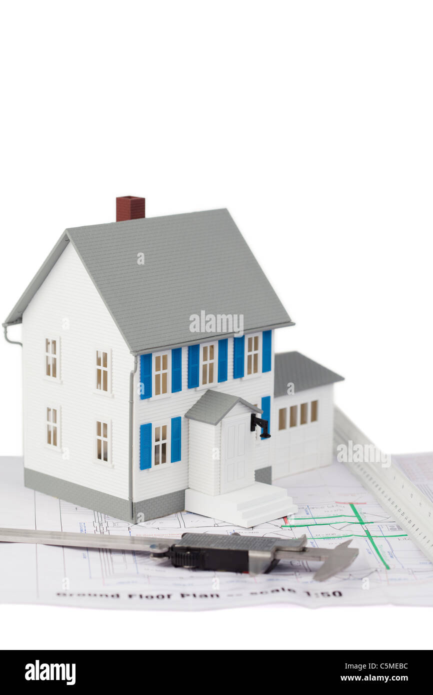 Toy house model and caliper on a ground floor plan Stock Photo