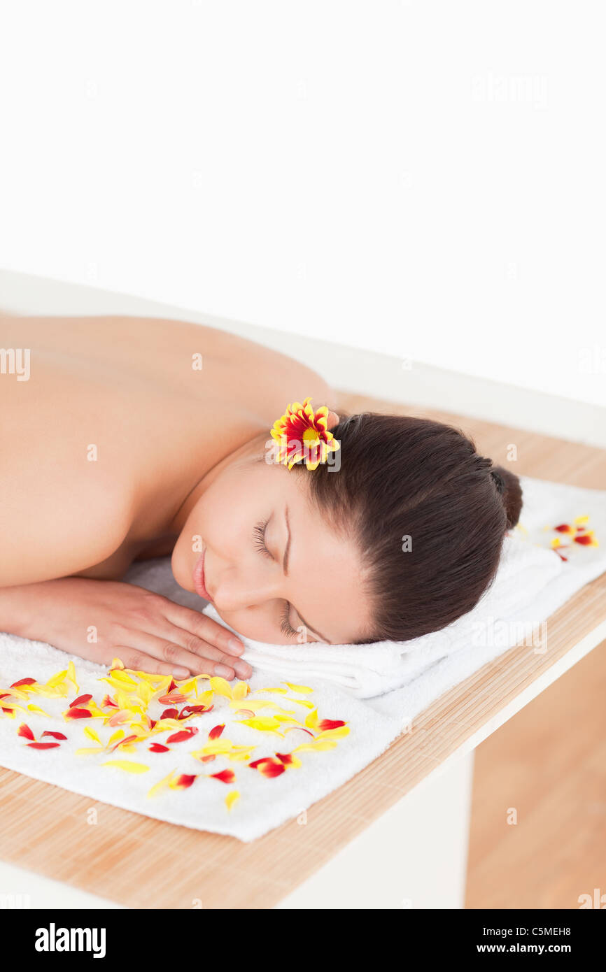 Cute woman closing her eyes while surrounded by flowers Stock Photo - Alamy