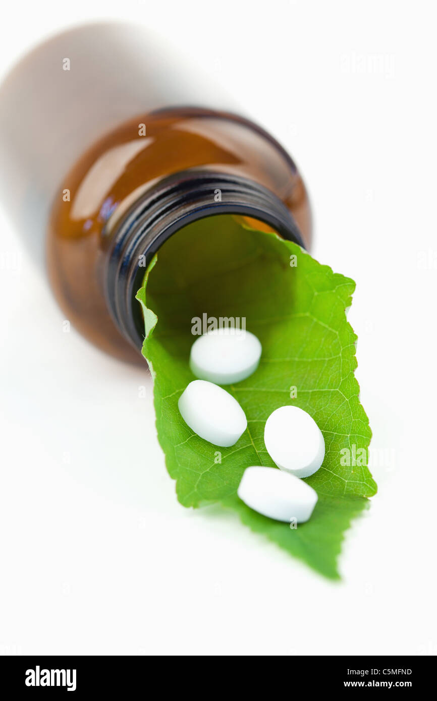 Leaf and pills in a small bottle Stock Photo