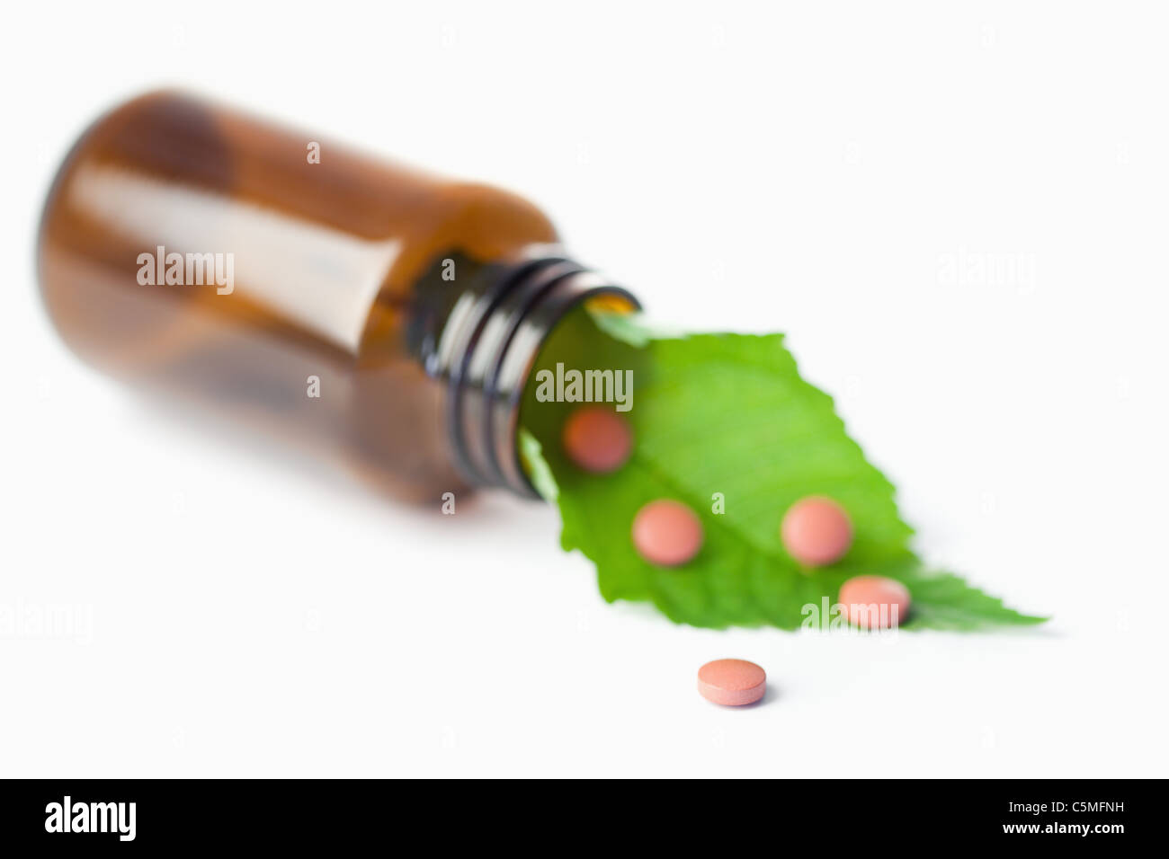 Leaf and pills in a small bottle Stock Photo
