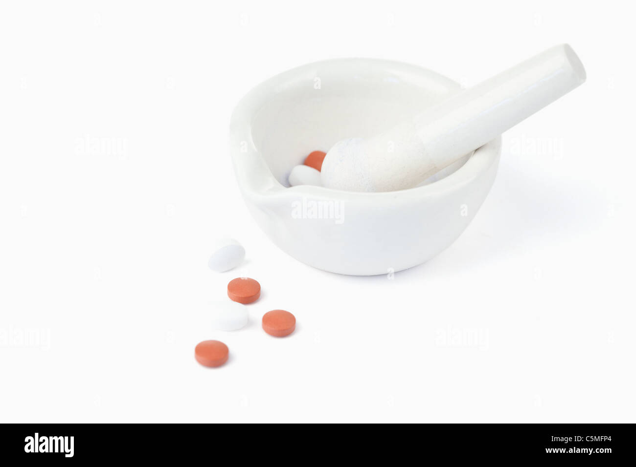 Mortar and pestle with pills Stock Photo