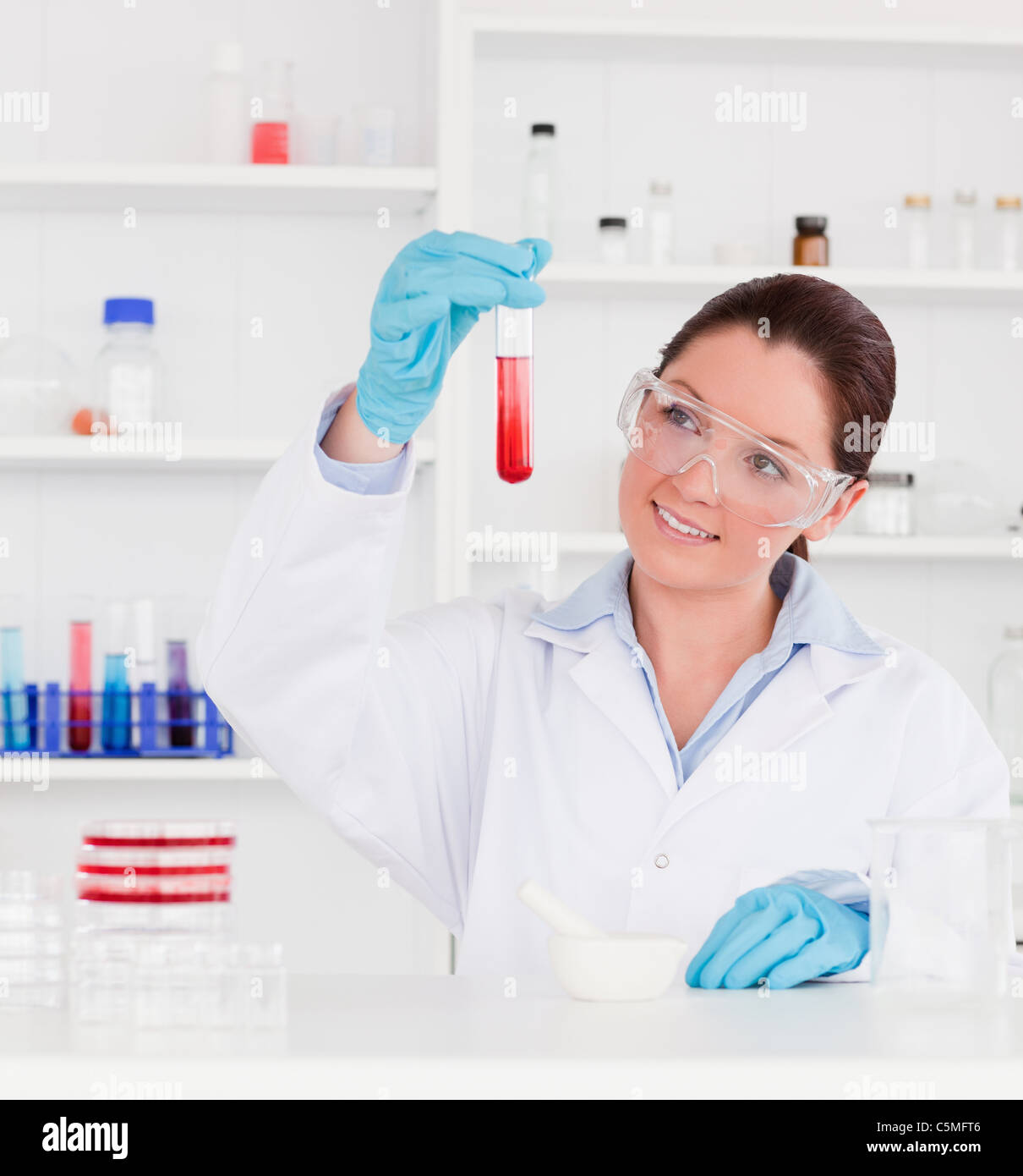 Cute scientist looking at a test tube Stock Photo