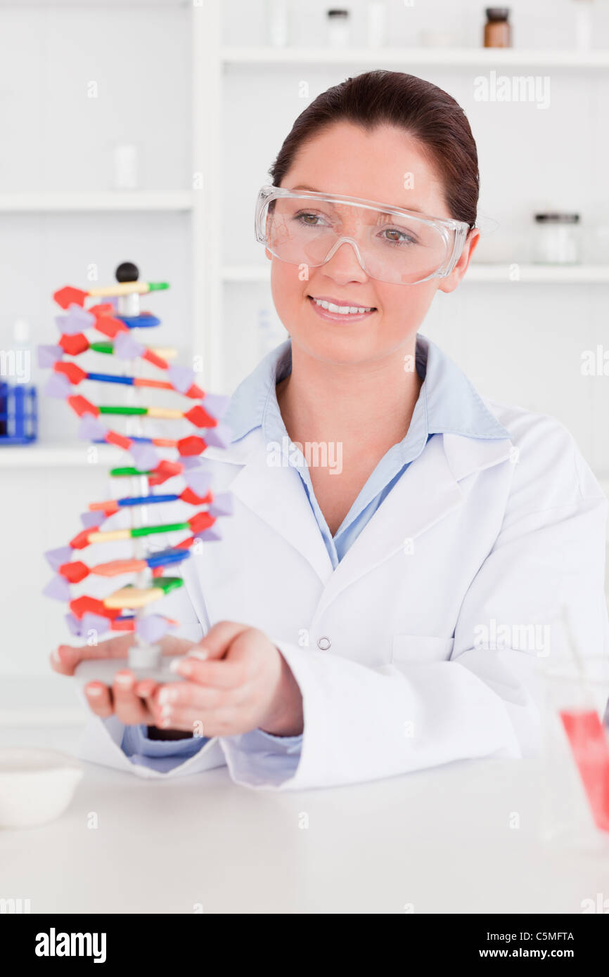 Cute scientist showing the dna double helix model Stock Photo