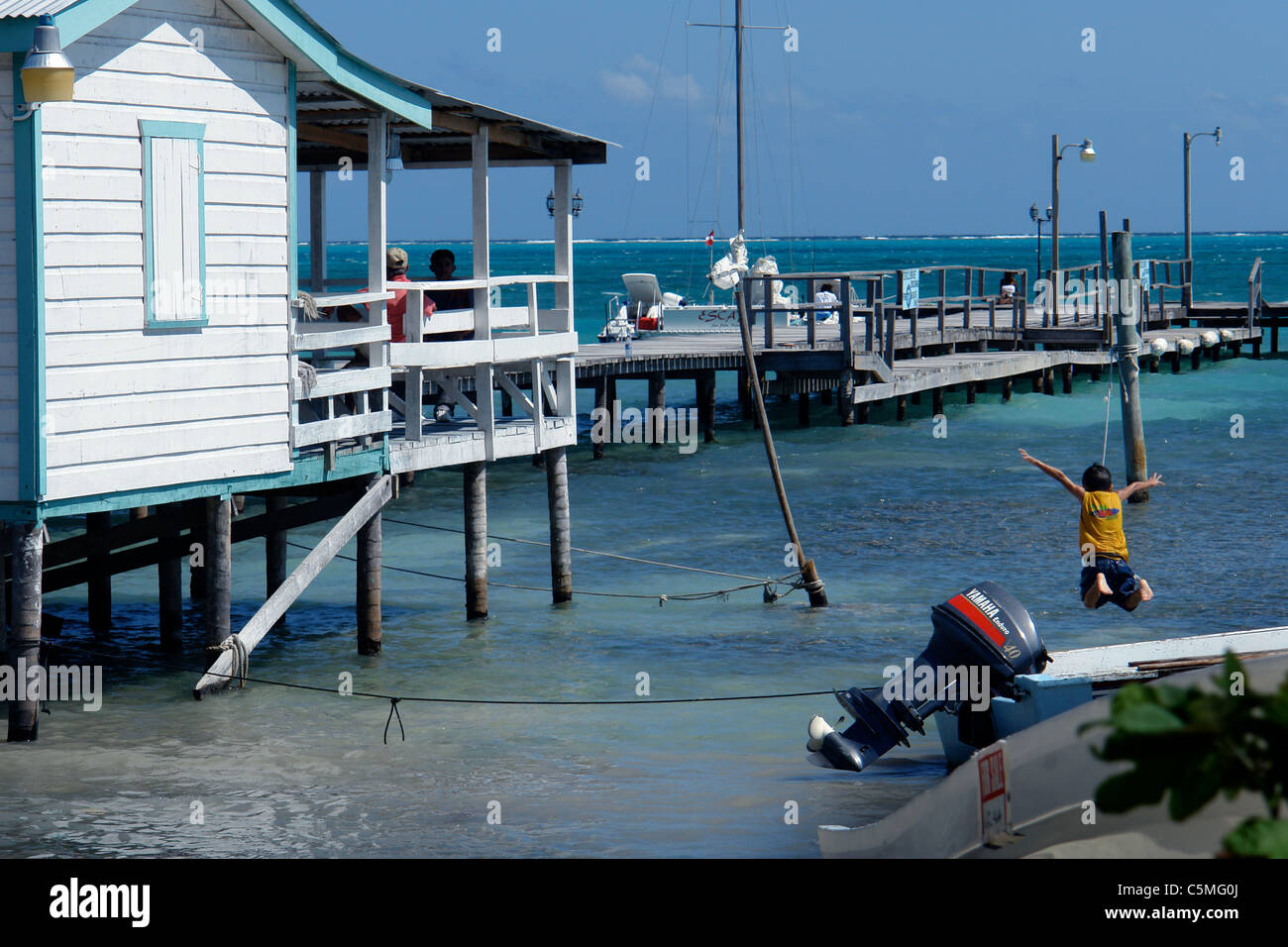 boy jumps off boat into water Stock Photo Alamy