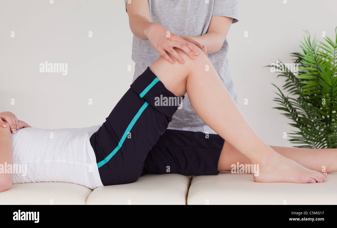 Masseuse massing the knee Stock Photo