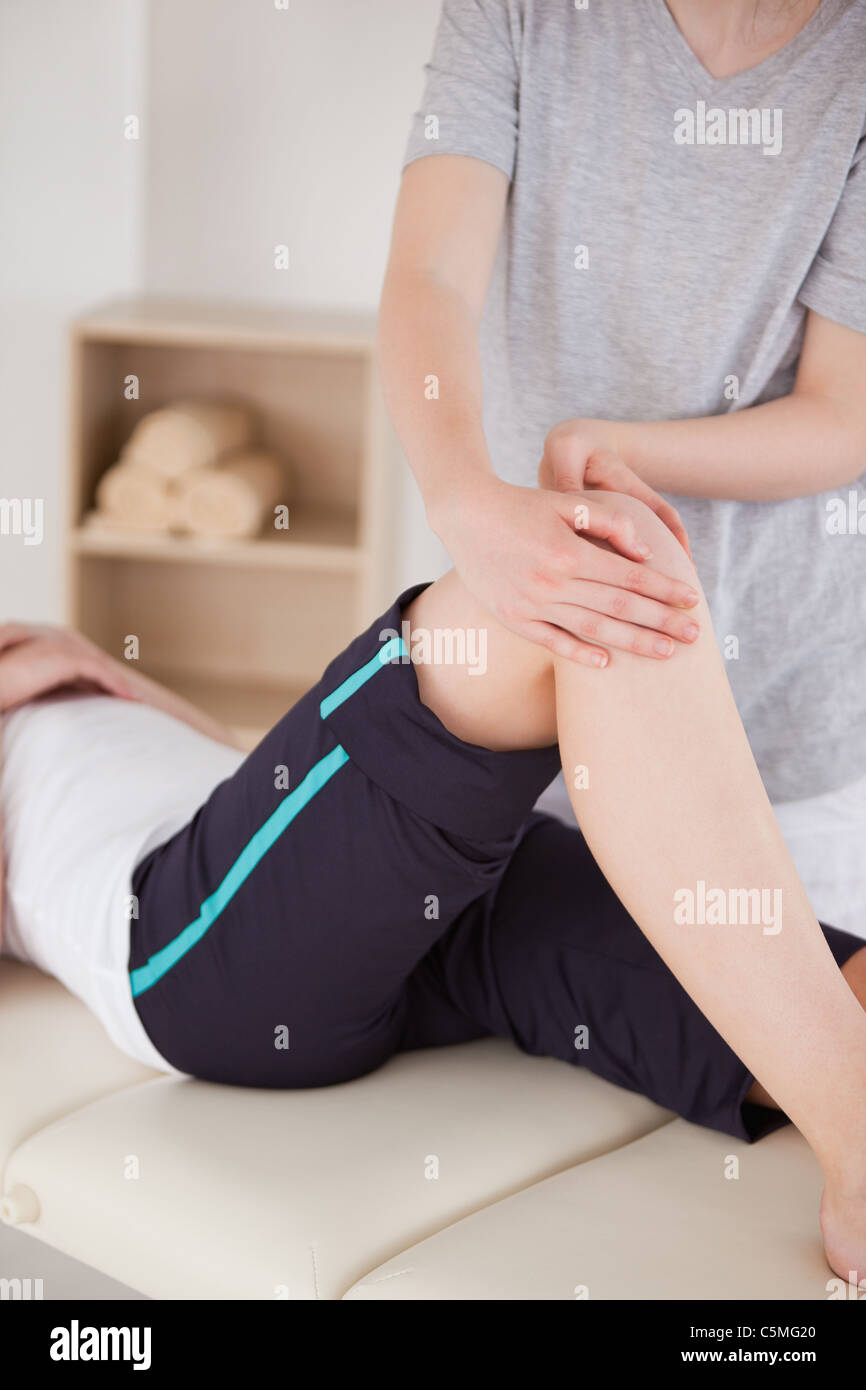 Portrait of a sportswoman having a knee massage Stock Photo