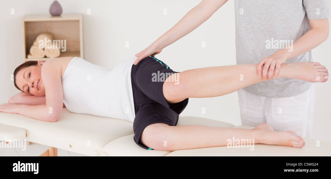 Sportswoman having a leg stretching Stock Photo