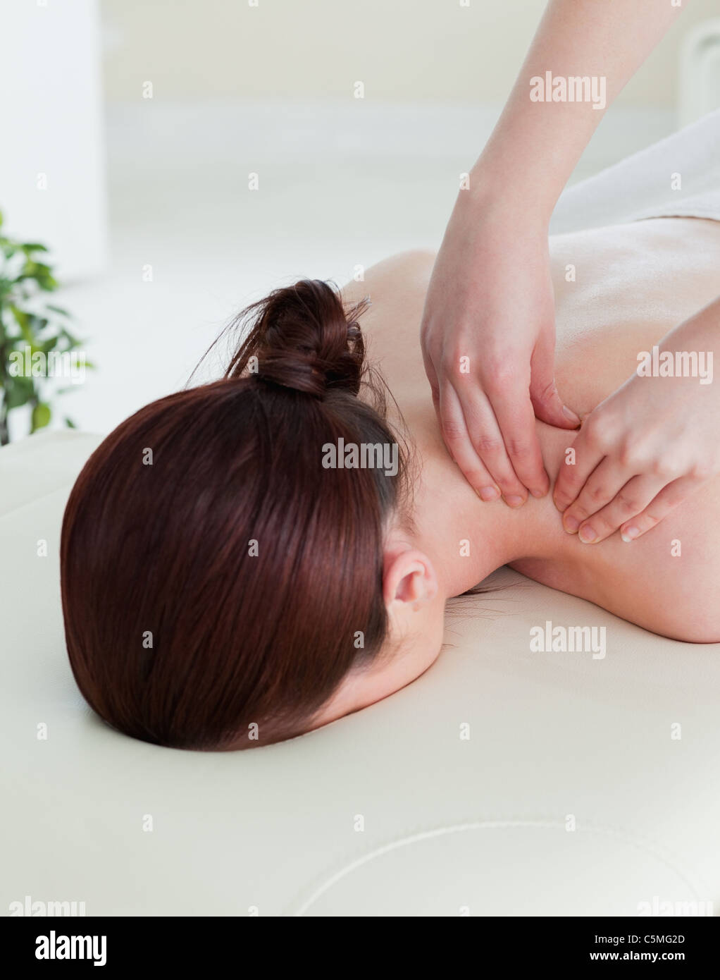Portrait of a red-haired woman having a rolling massage Stock Photo