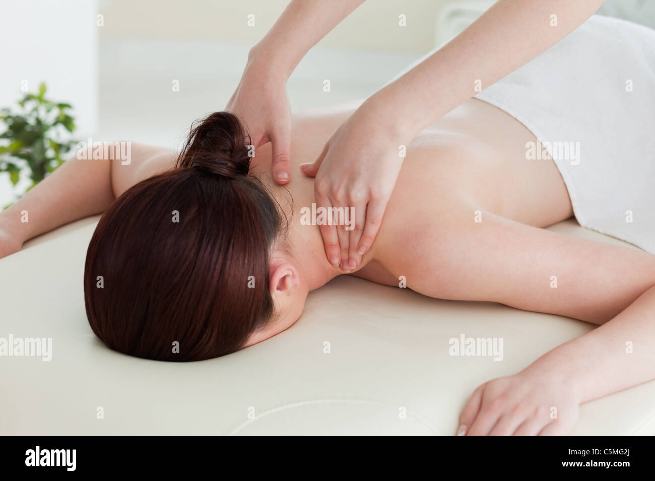 Close up of a young woman having a shoulder massage Stock Photo