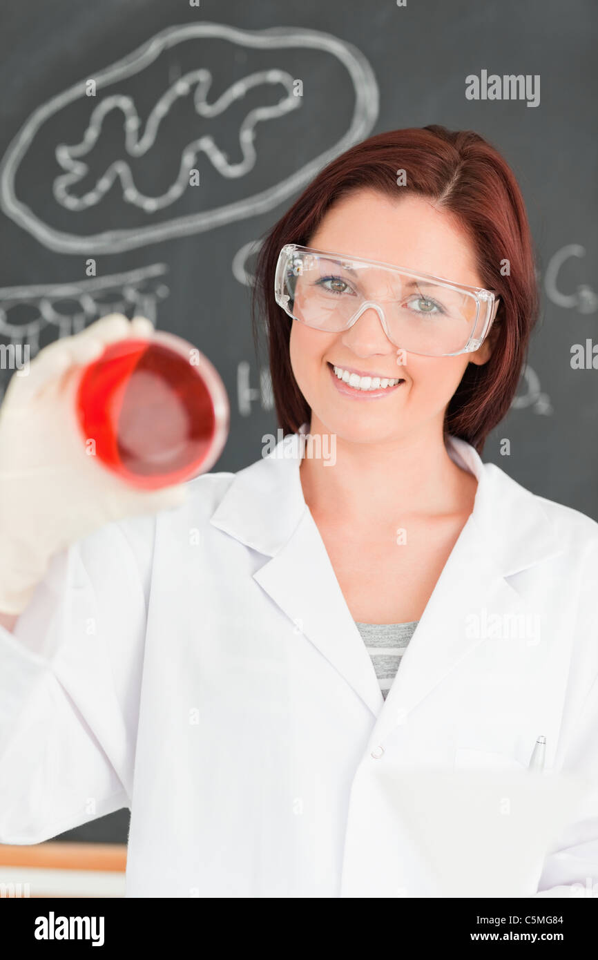 Smiling red-haired scientist looking at a petri dish Stock Photo - Alamy