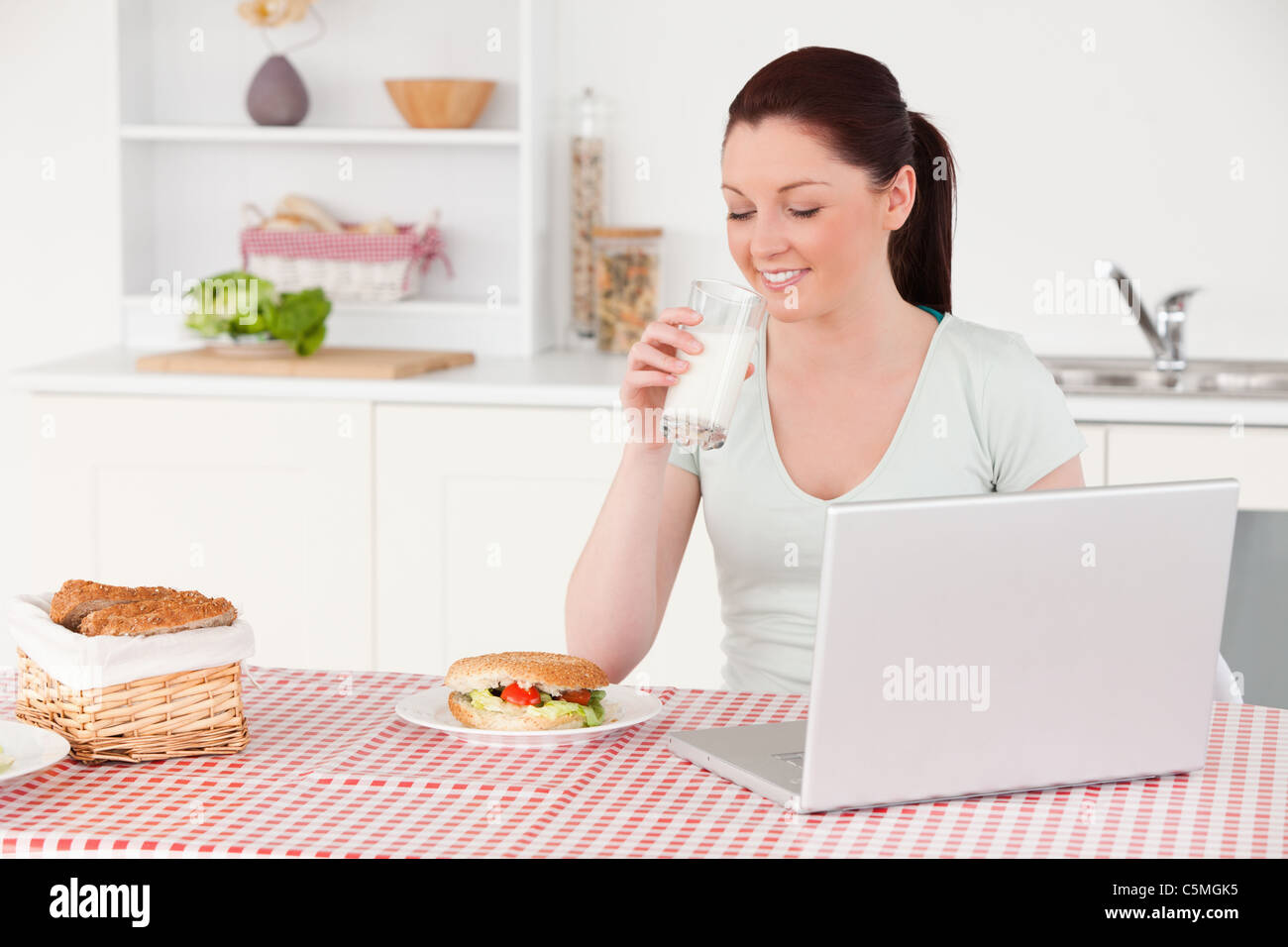 Good looking woman posing with a glass of milk while relaxing Stock Photo