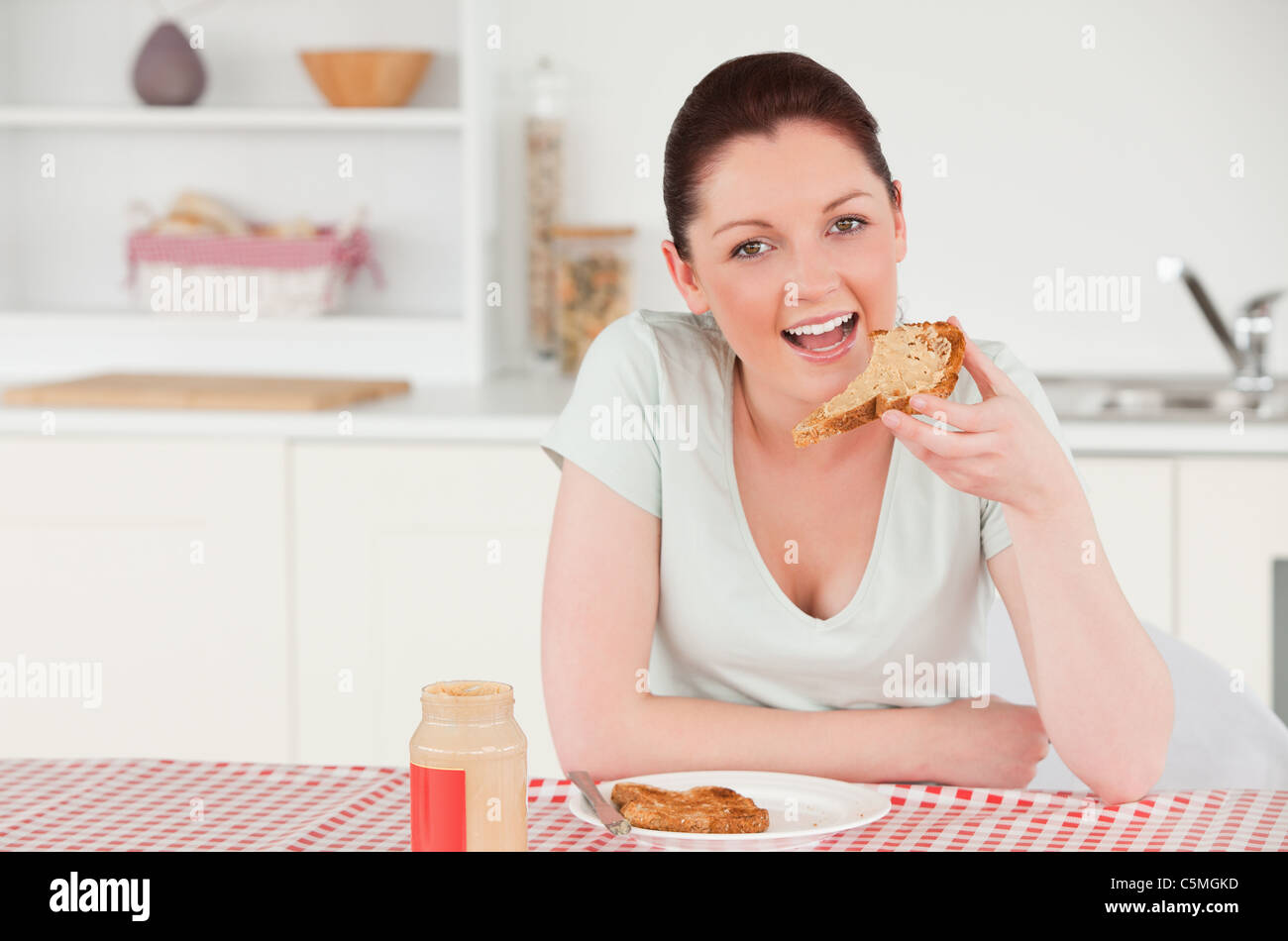 Good looking woman posing while eating a slice of bread Stock Photo