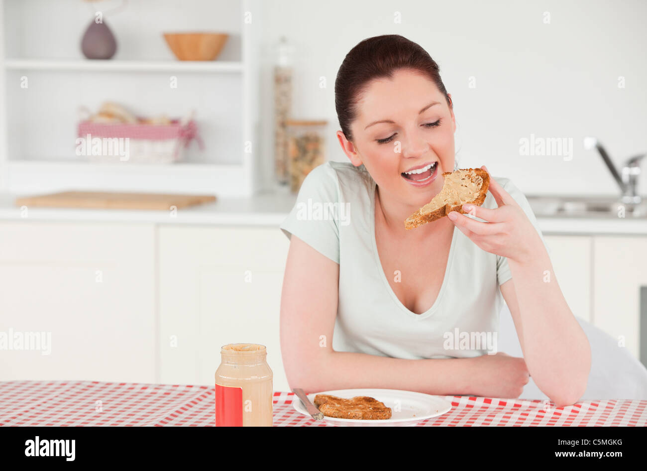 Attractive woman posing while eating a slice of bread Stock Photo