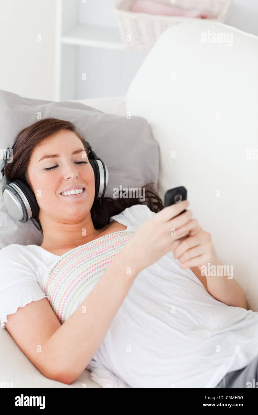Charming brunette woman writing a text on her mobile Stock Photo - Alamy