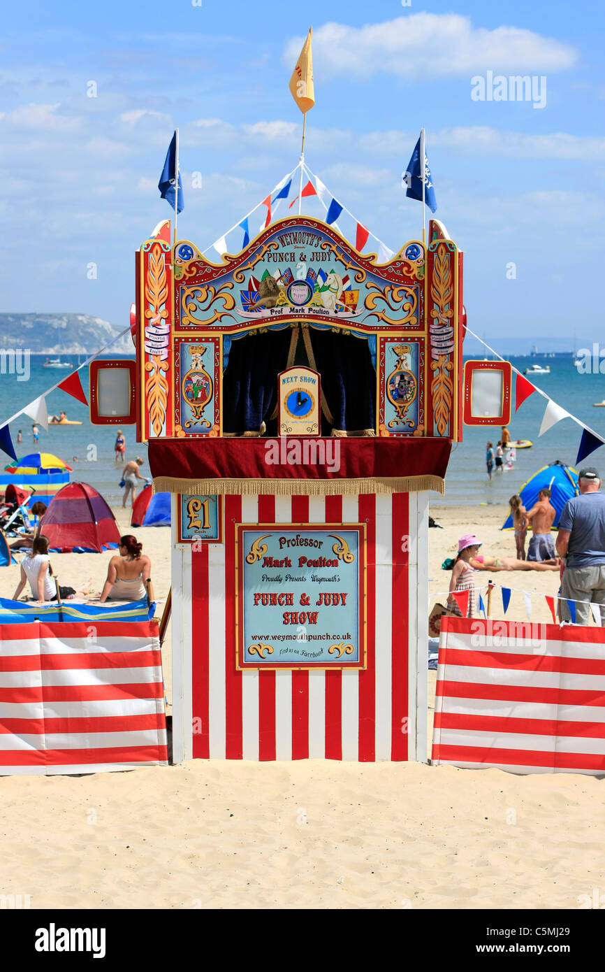 Traditional Punch and Judy show on the beach at Weymouth Dorset Stock