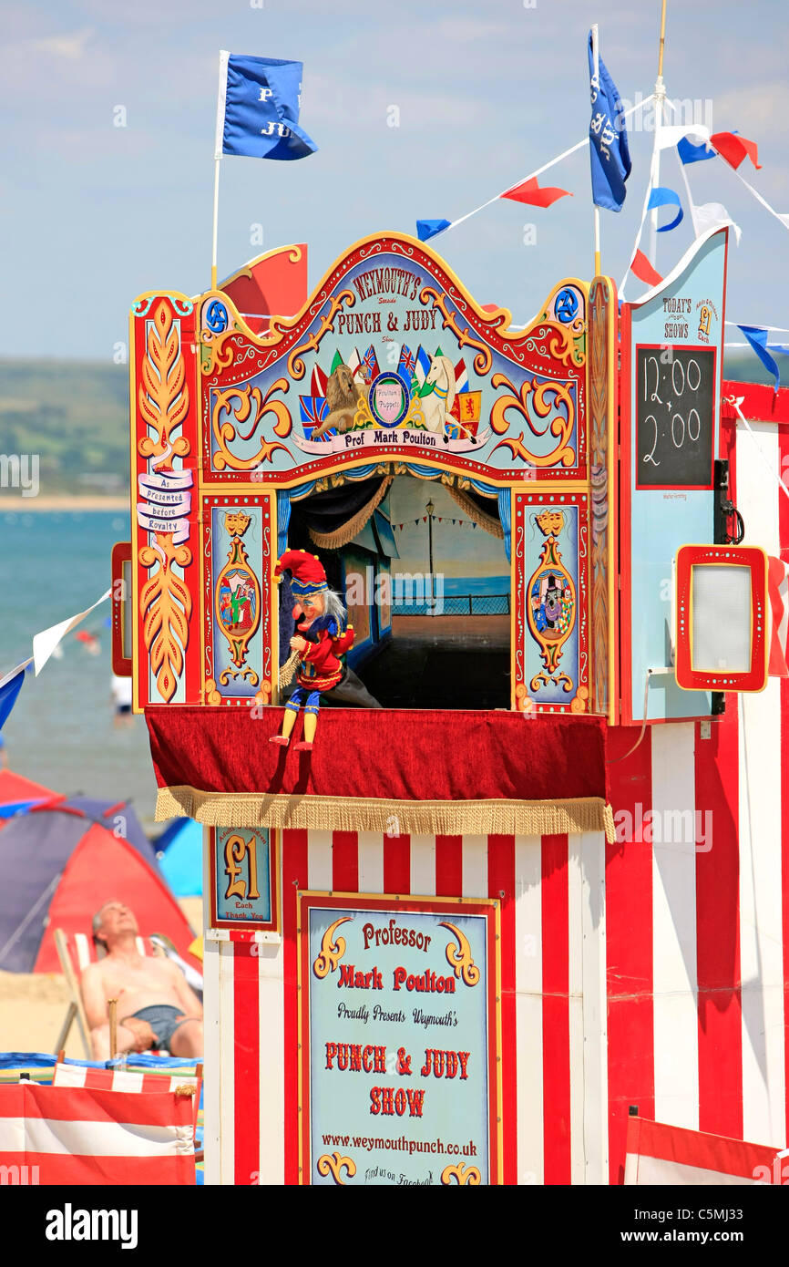 Traditional Punch and Judy show on the beach at Weymouth Dorset Stock