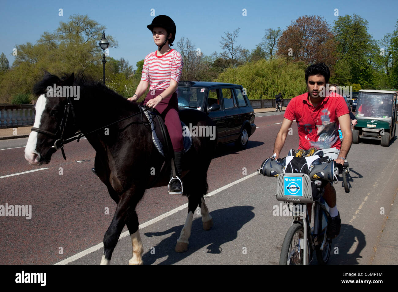 Horse riding in Hyde Park along a stretch of cycle path sharing the