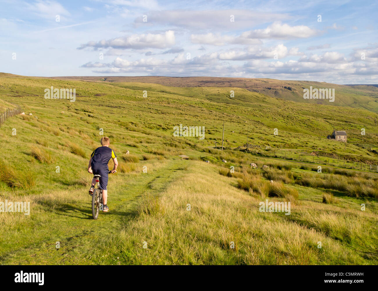 Boy mountain cycling at Brun Clough on Marsden Moor in the Pennines, England, UK; Yorkshire - Lancashire border Stock Photo