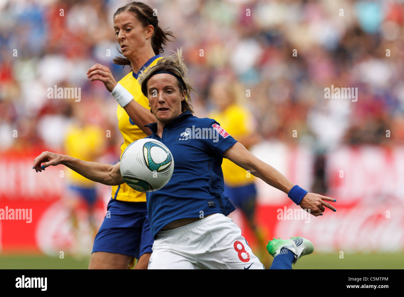 Sonia Bompastor of France (8) sets to clear the ball ahead of Lotta Schelin of Sweden during 2011 Women's World Cup 3rd place Stock Photo