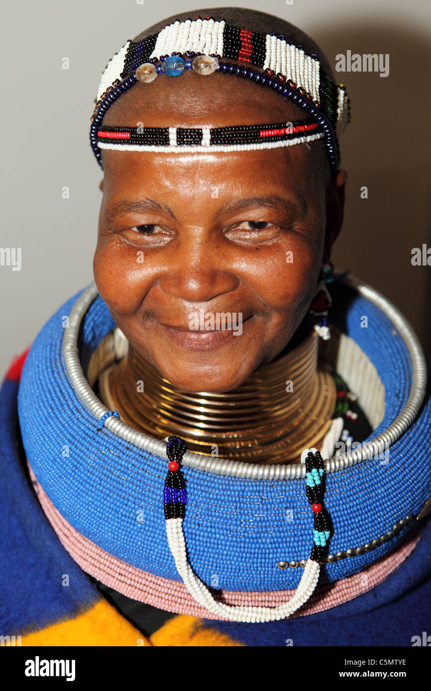 A Ndebele woman wears traditional tribal attire. Stock Photo