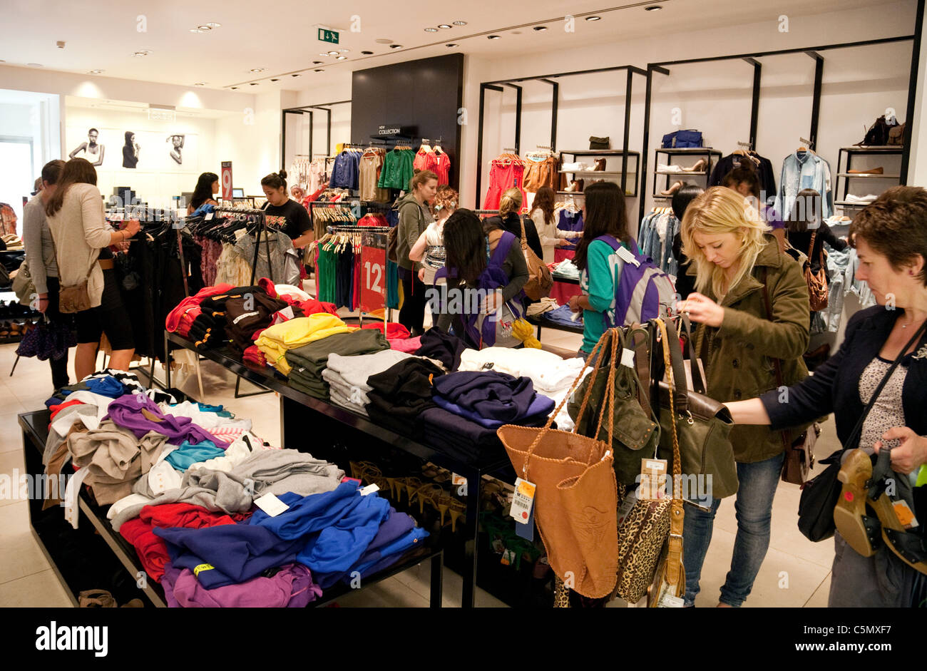 Women shopping for clothes in the sales, London UK Stock Photo