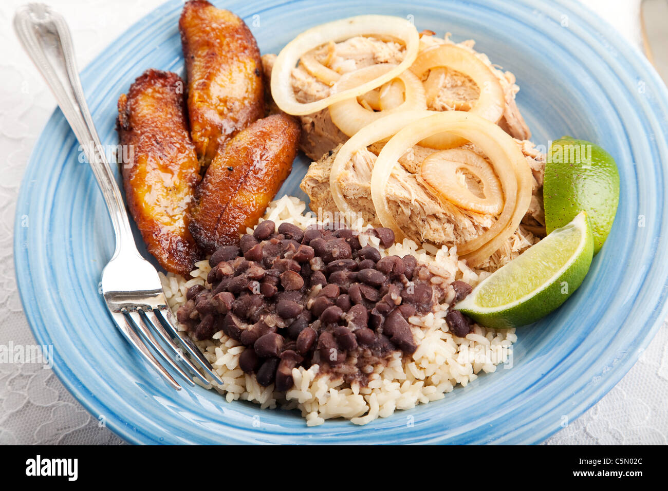 Cuban dinner, consisting of roast pork, black beans and rice, and fried