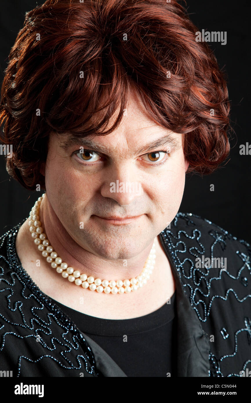 Drag queen dressed as a female celebrity. Portrait on black background.  Stock Photo