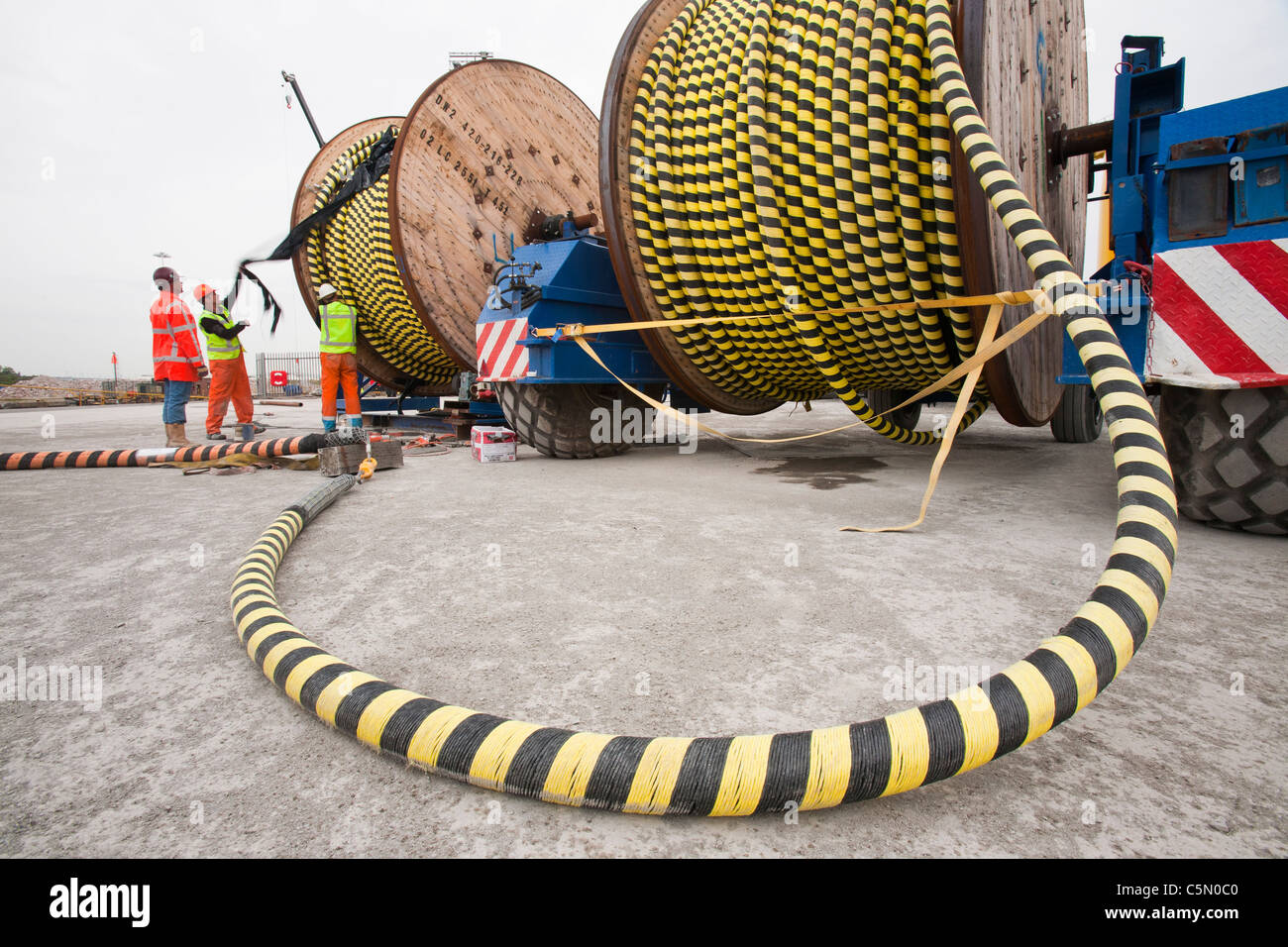 Offshore electric cabling for the Walney Offshore windfarm project being loaded onto a cable laying vessel in the docks Stock Photo