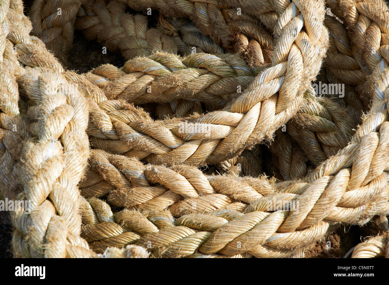 Coil of heavy natural fibre rope pat of a fishing net Stock Photo Alamy