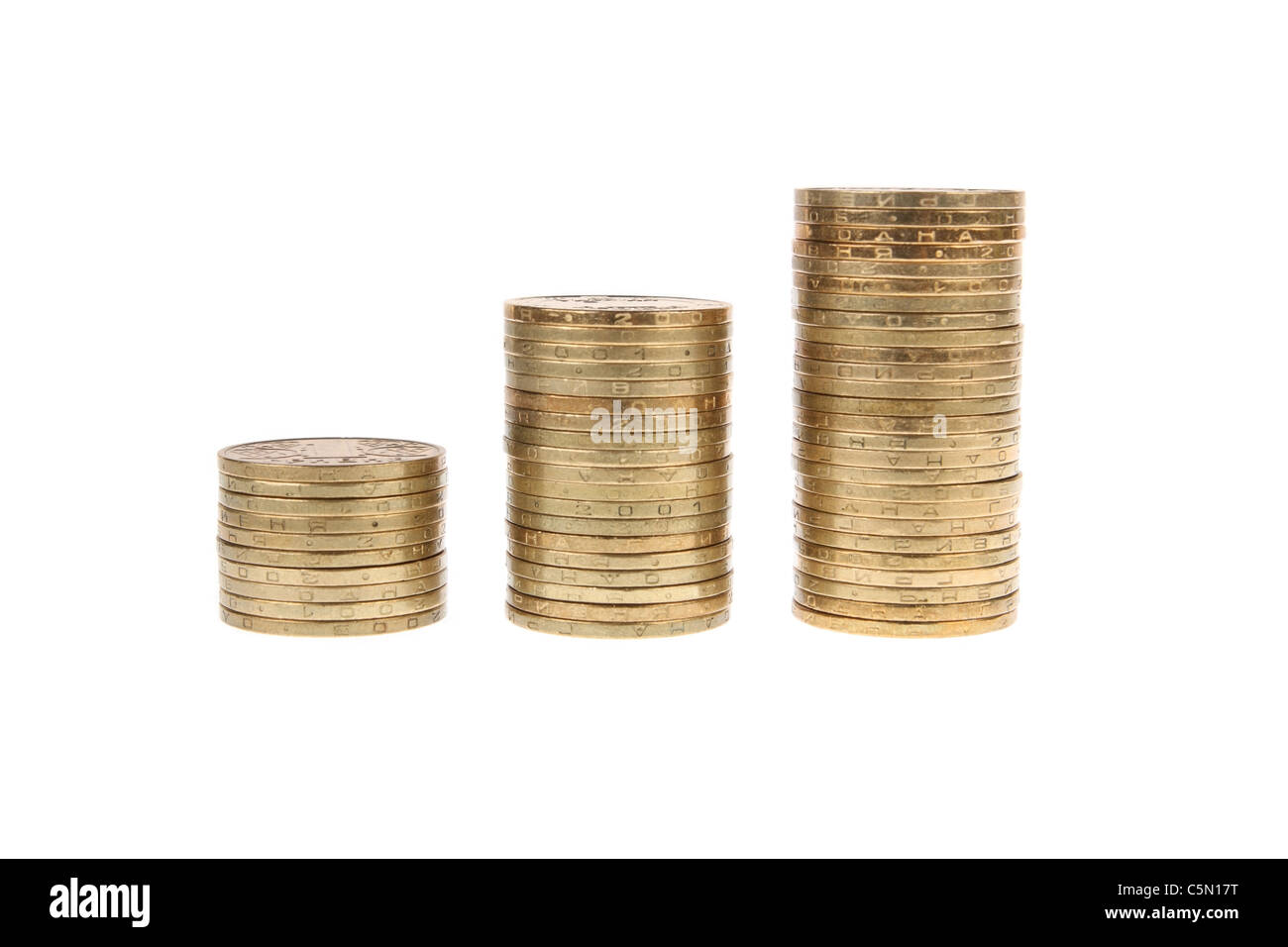 It shows the piles of coins on white background Stock Photo - Alamy