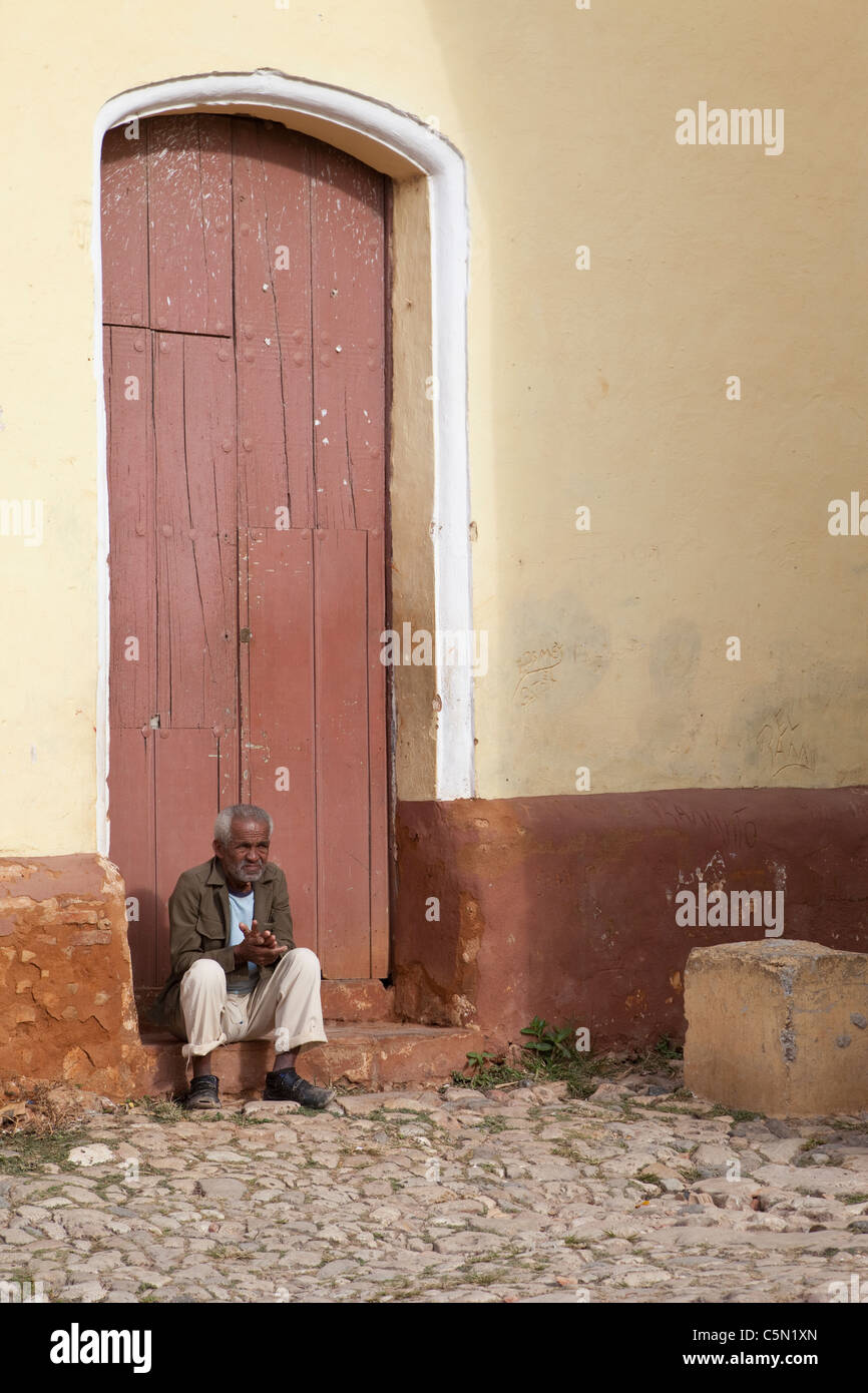 Cuba Trinidad Old Man Sitting On Door Stoop Stock Photo