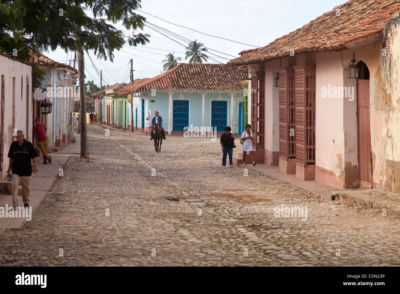 Cuba, Trinidad. Late Afternoon Street Scene. Man on Horseback. Stock Photo