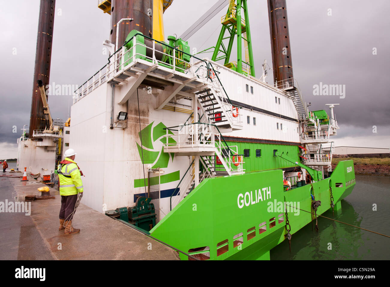 The  jack up barge, Goliath being towed out by tug to the Walney offshore wind farm, Cumbria, UK. Stock Photo
