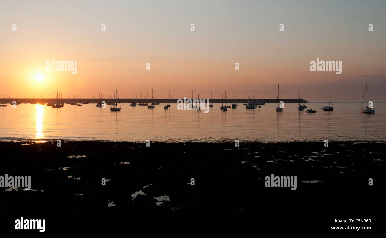 Sunset over breakwater, Alderney, Channel Islands Stock Photo