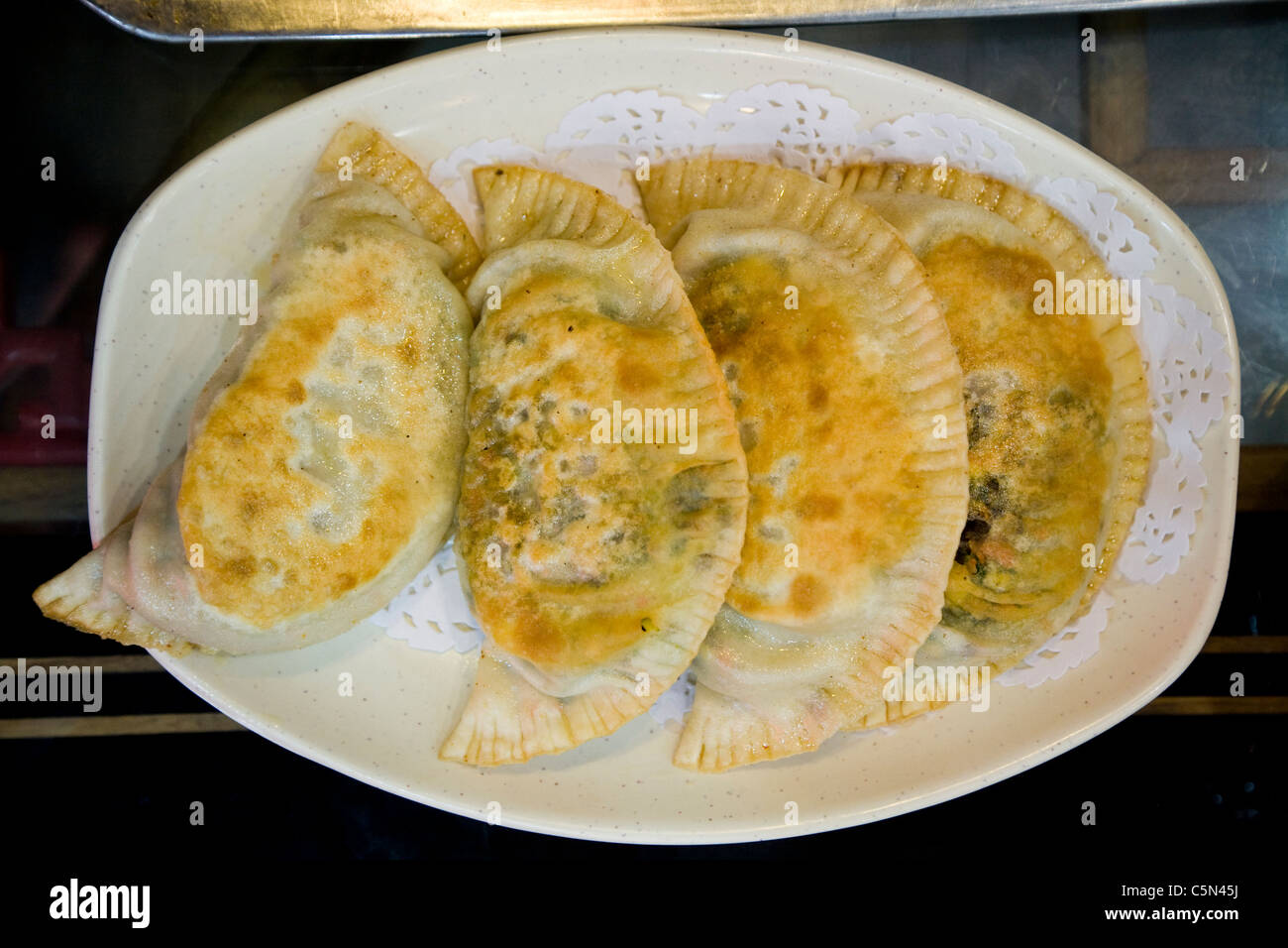 A plate / dish side order of fresh / authentic / real Chinese dumpling