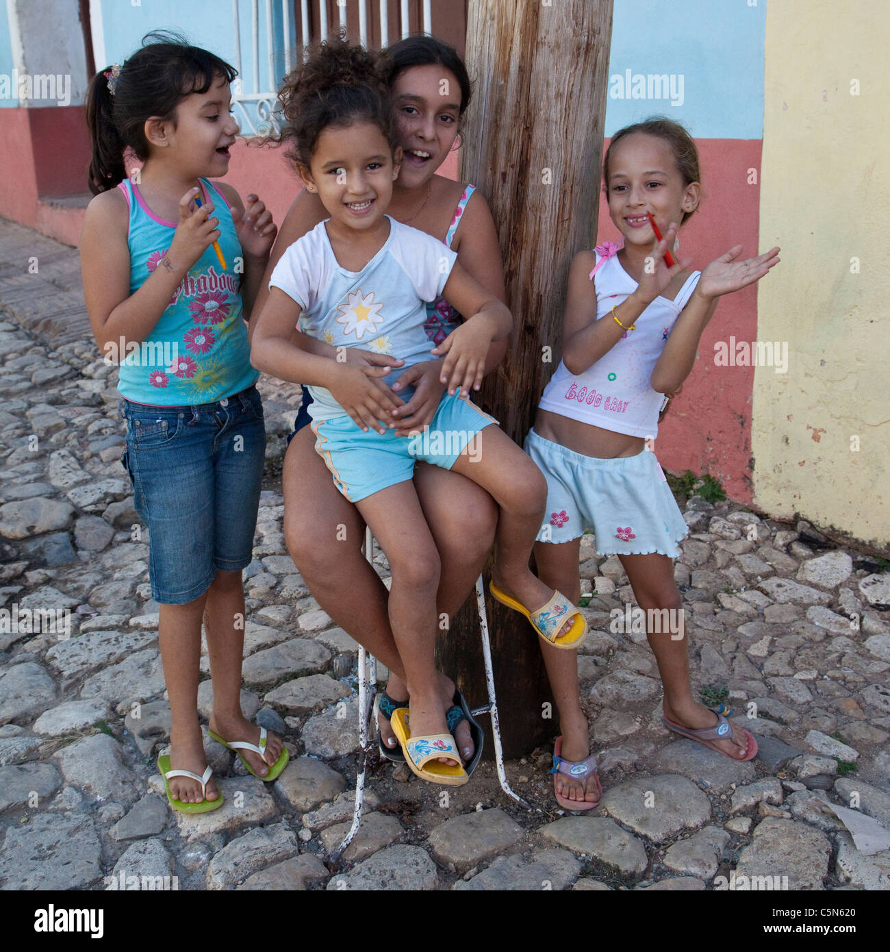 School girl says hello to some younger friends - CIENFUEGOS, CUBA Stock Pho...