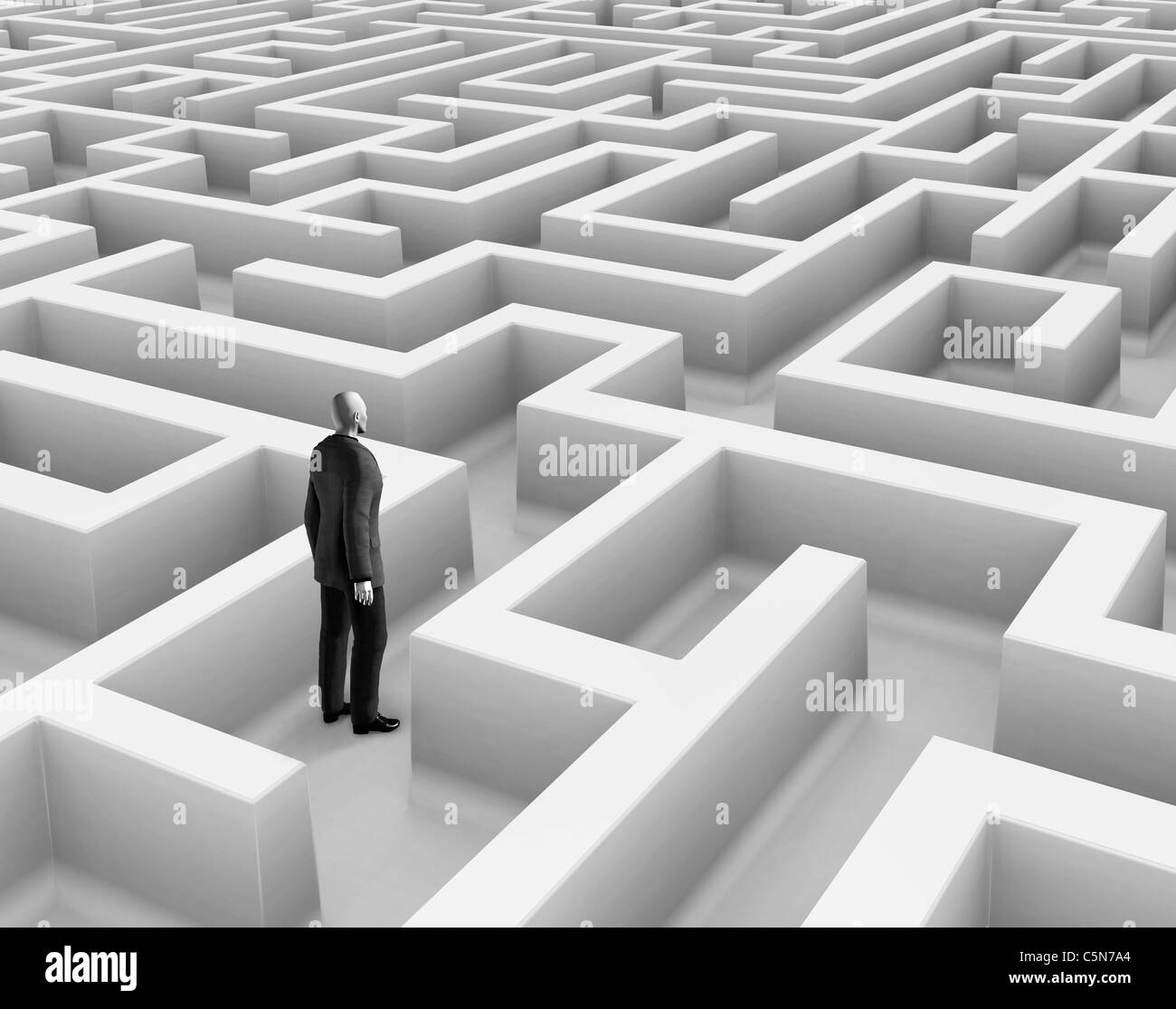 Man wearing a suit standing in maze. Stock Photo